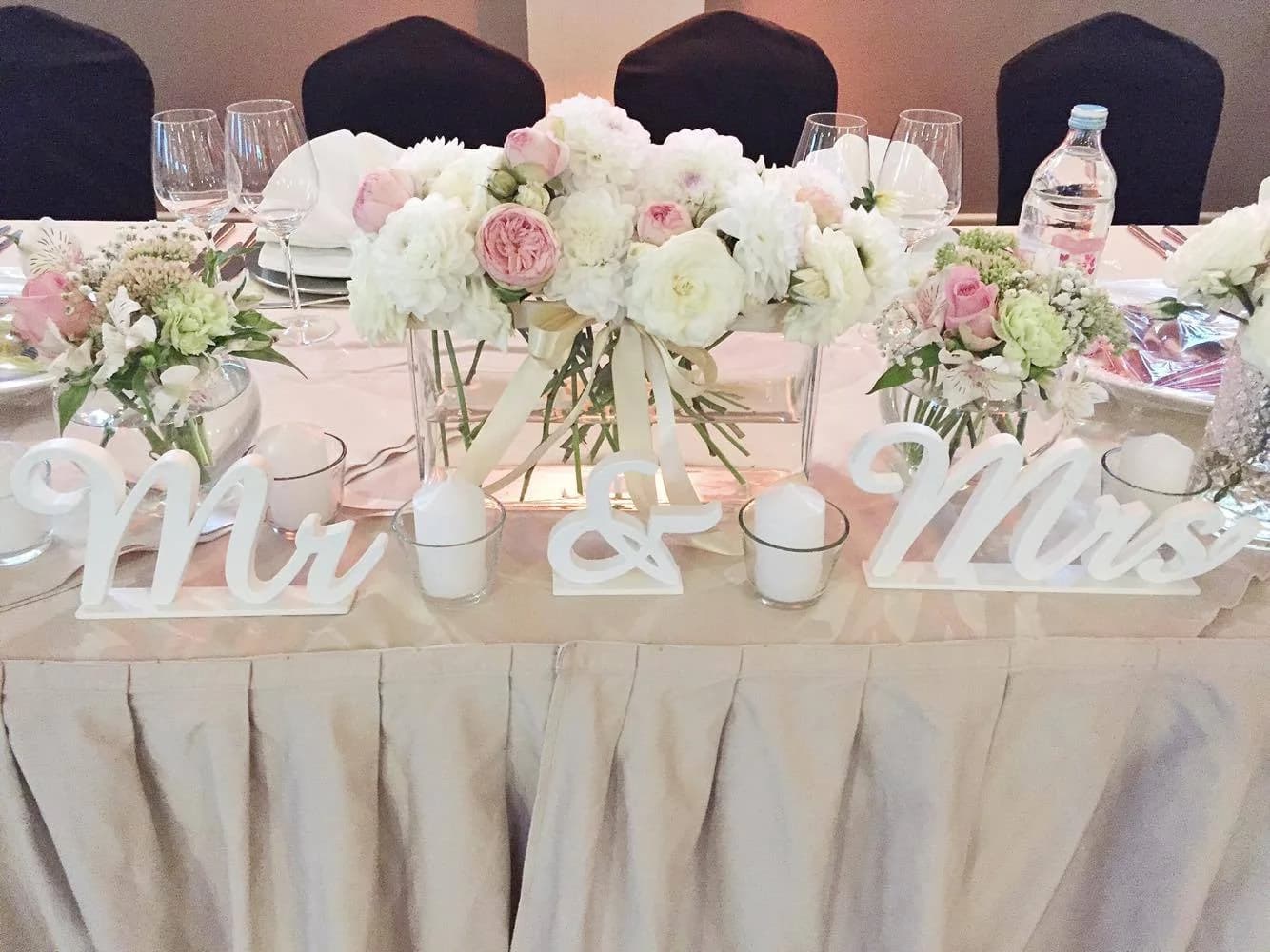 Elegantly set wedding table with floral arrangement
